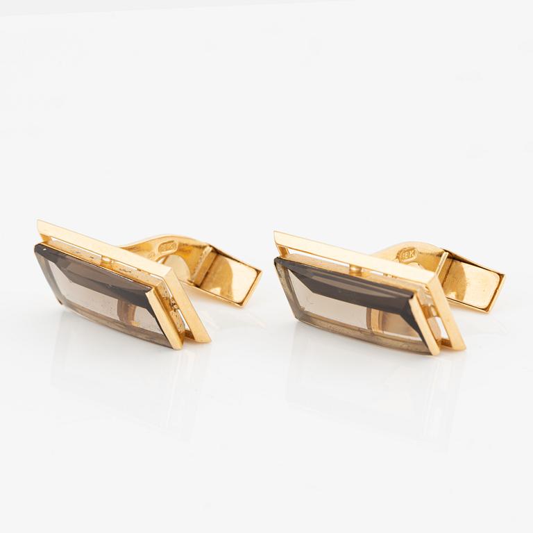 A pair of cufflinks in 18K gold with smoky quartz.