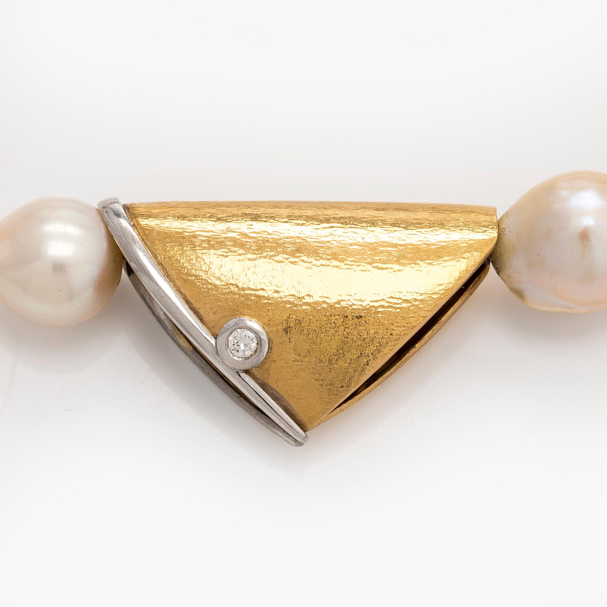Ole Lynggaard, A cultured pearl necklace, clasp in 18K gold with a round brilliant-cut diamond.