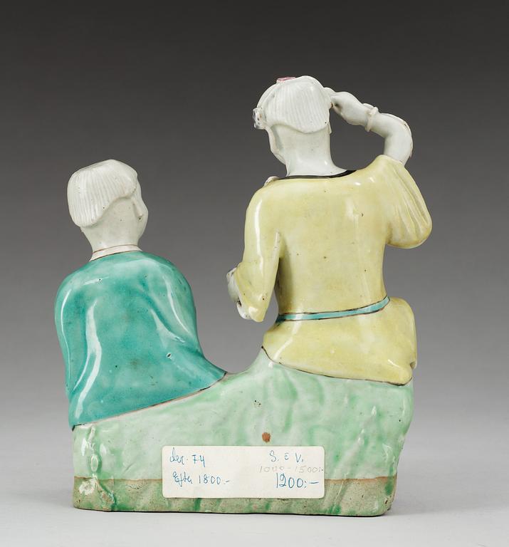 A famille rose figure of two boys, Qing dynasty, ca 1800.