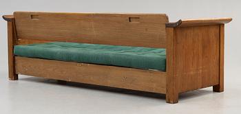 An Axel Einar Hjorth stained pine sofa 'Sandhamn', by Nordiska Kompaniet ca 1929.