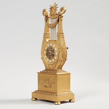 A French Empire early 19th century gilt bronze mantel clock.