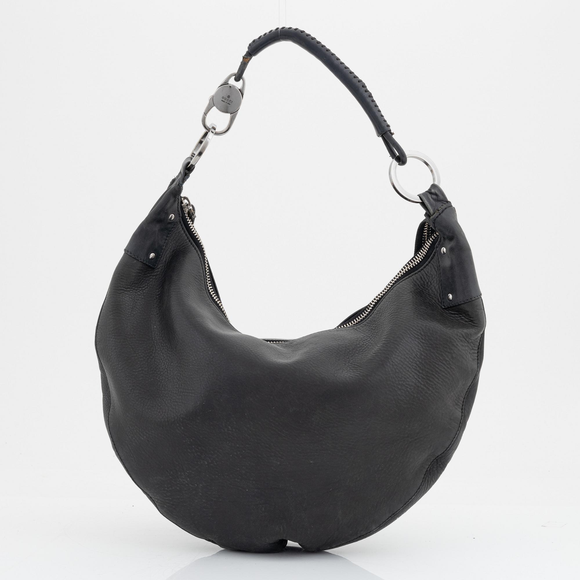 Gucci, a leather bag.