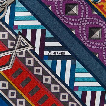 Hermès, a 'Collier de Chiens Maxi Twilly' silk scarf.