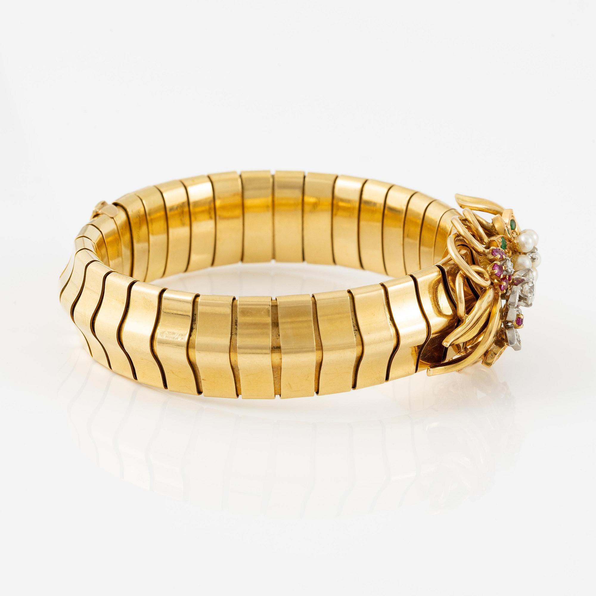 A Strömdahls bracelet/pendant combination in 18K gold with rubies, emeralds, pearls and diamonds.