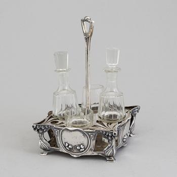 An Art Nouveau early 20th century silver cruet-set for four glass containers, unknown master.