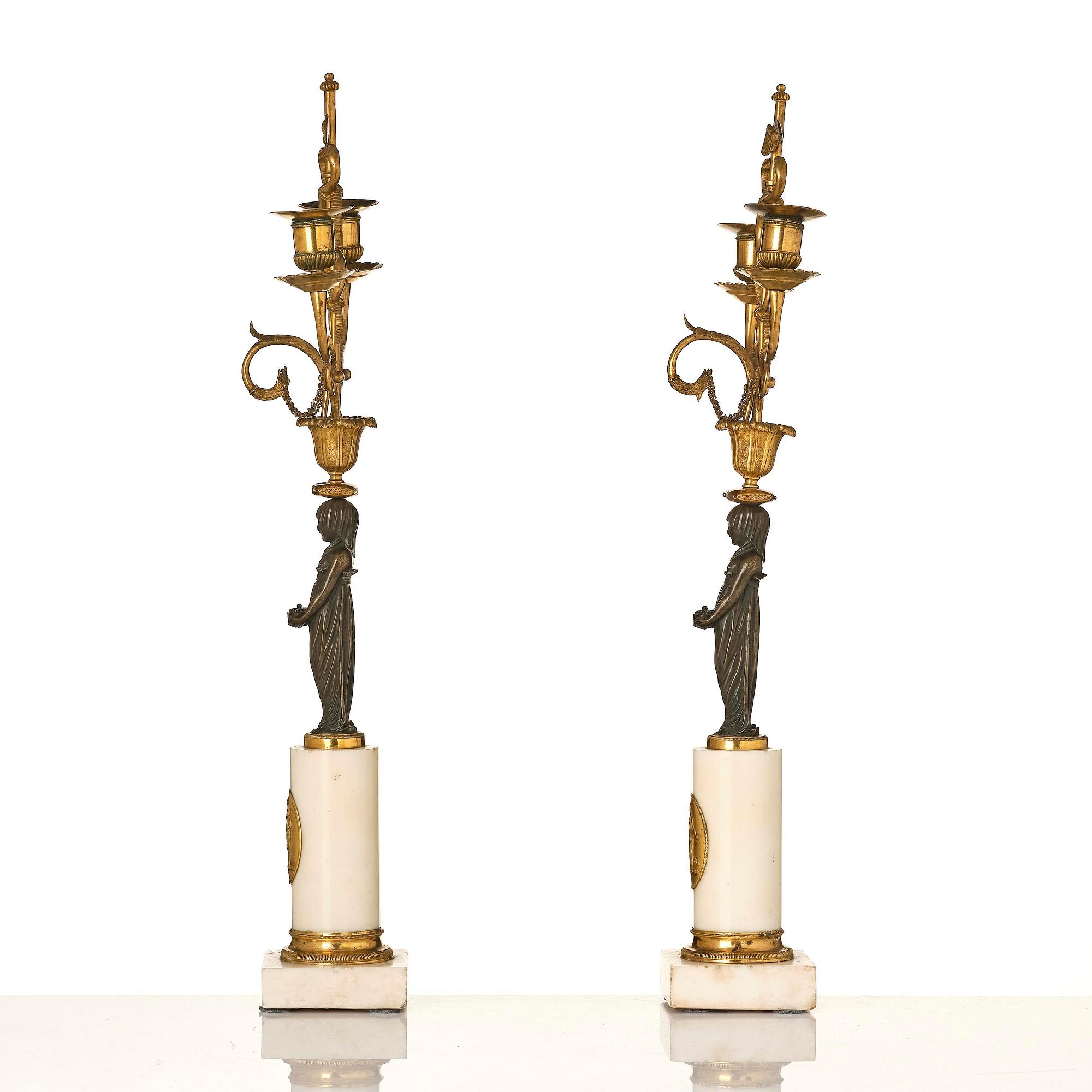 A pair of late Gustavian white marble and bronze candelabra.