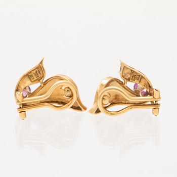 A pair of 18K gold earrings.