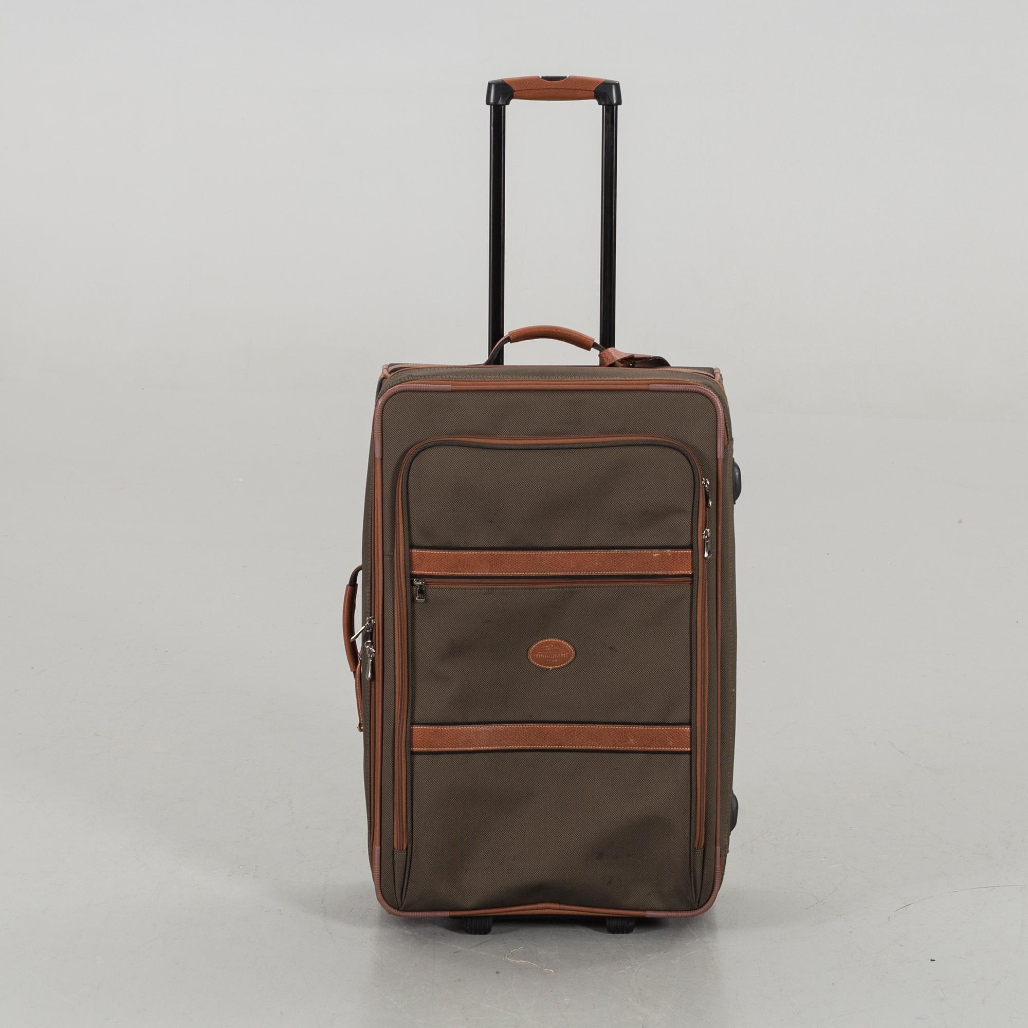 A LONGCHAMP SUITCASE.