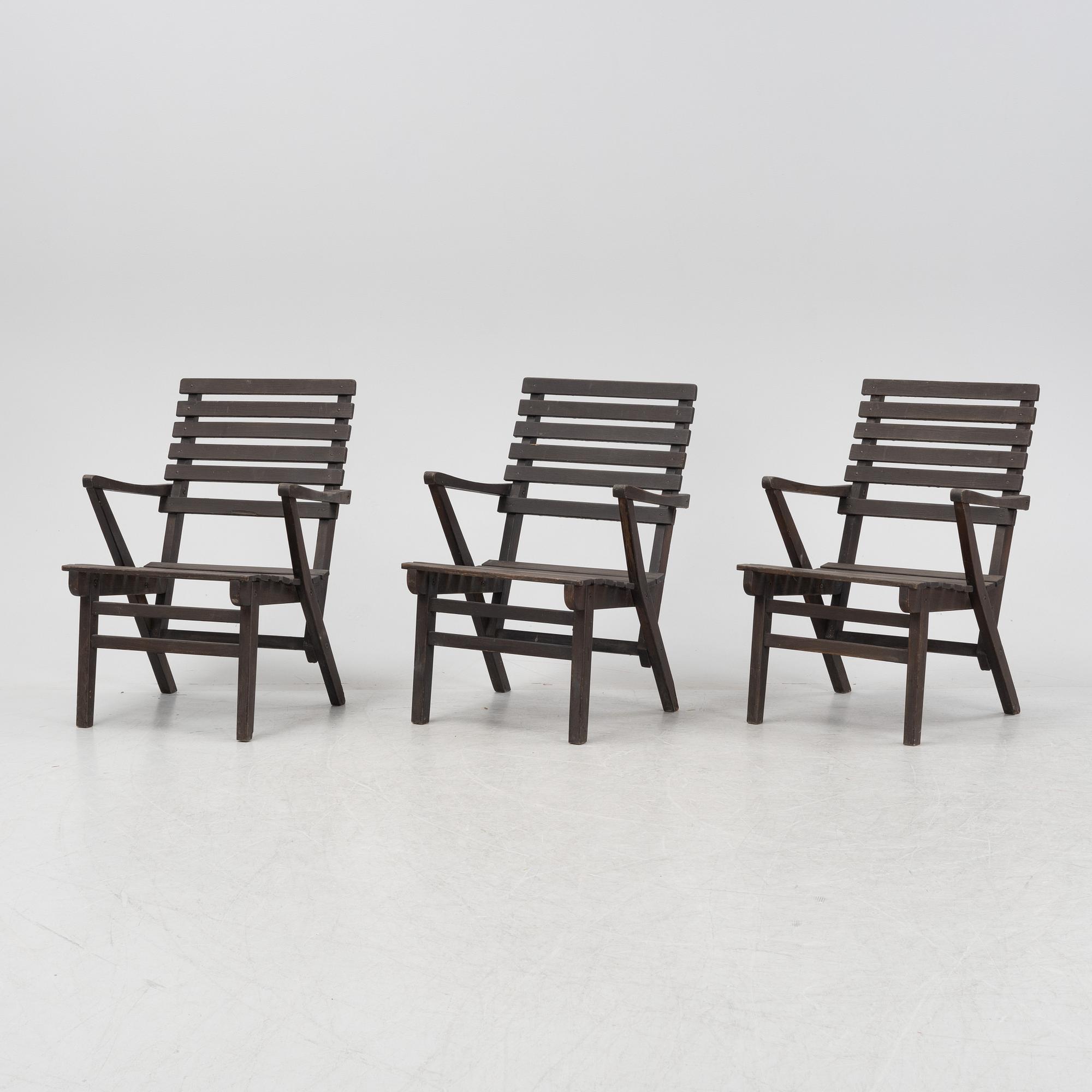 Carl Malmsten, a set three stained pine armchairs, Igelstaverken, second half of the 20th Century.