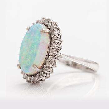 A 14K white gold ring with a probably real opal and diamonds ca. 0.65 ct in total.