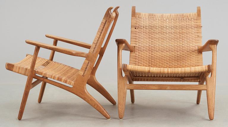 A pair of Hans J Wegner oak and rattan 'CH-27' armchairs, Carl Hansen & Son, Denmark, 1950's-60's.