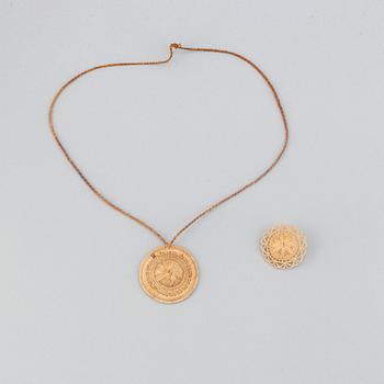 A Sami root brooch and pendant.
