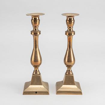 A PAIR OF EMPIRE CANDLESTICKS.