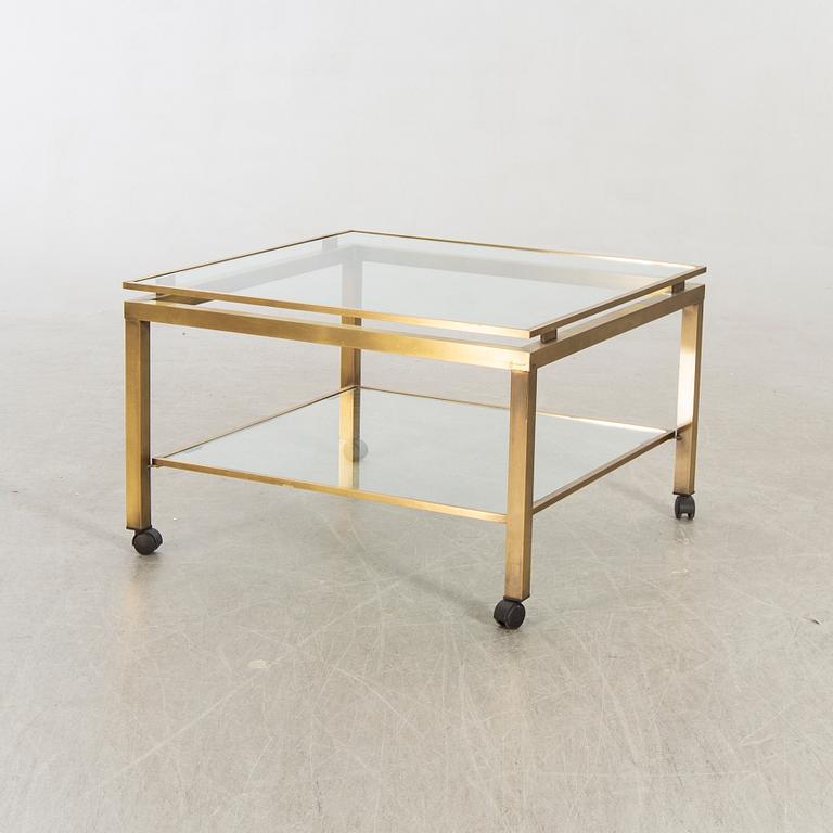 A brass and glass top coffee table.