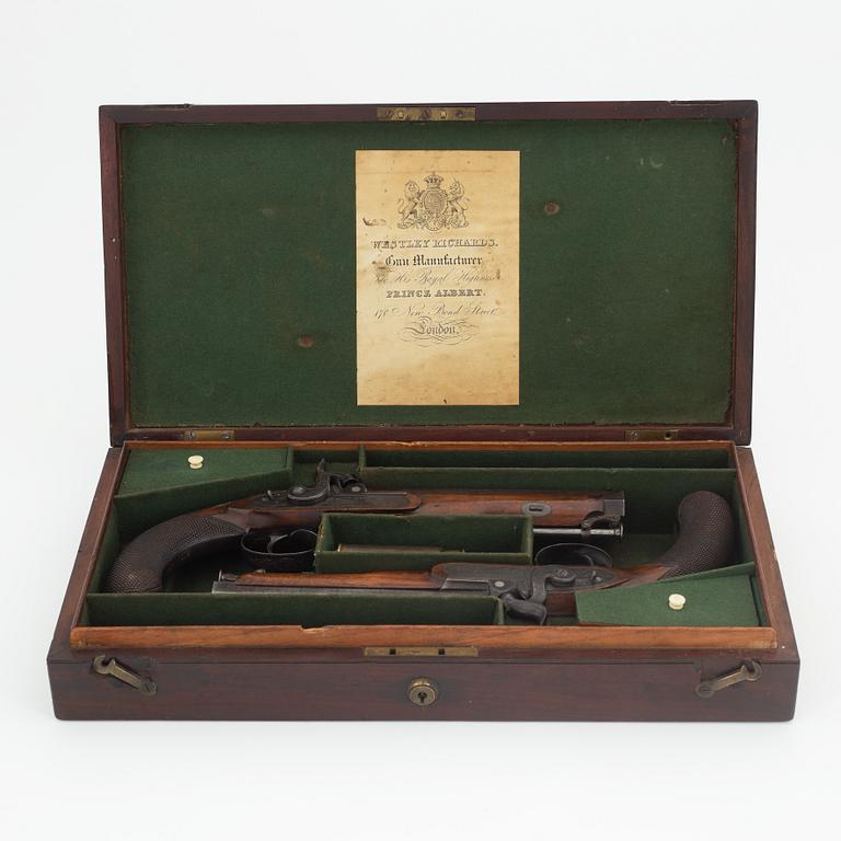 A cased pair of percussion pistols by Westley Richards, London, mid 19th Century.