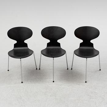 An Arne Jacobsen "Centenary Package" comprising three "Ant Chairs" and an eggshaped table, Fritz Hansen, Denmark.