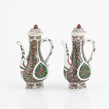 A pair of famille verte ewers and covers, 20th century.