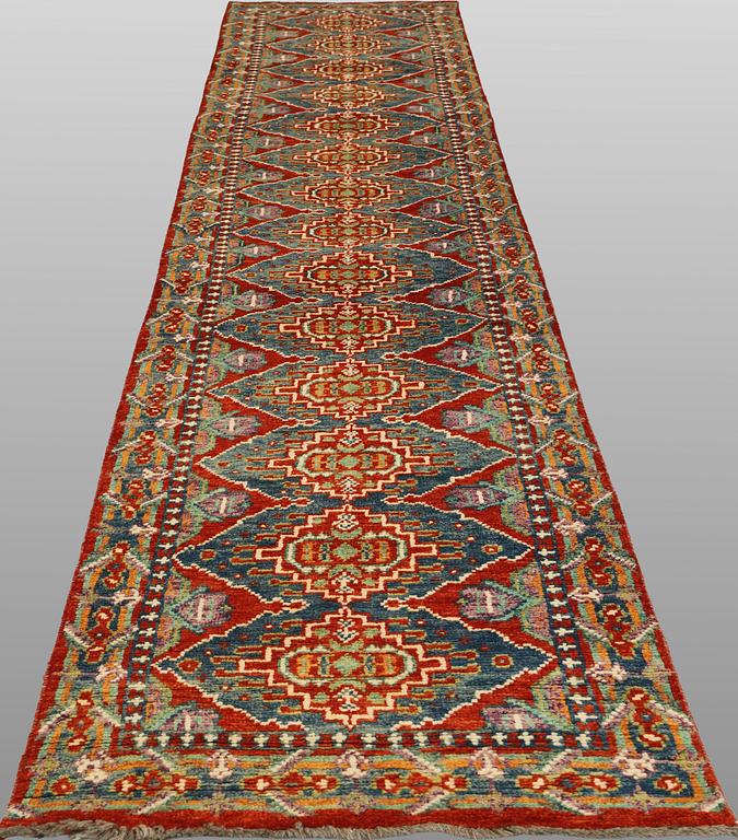 An oriental runner, c. 386 x 78 cm.