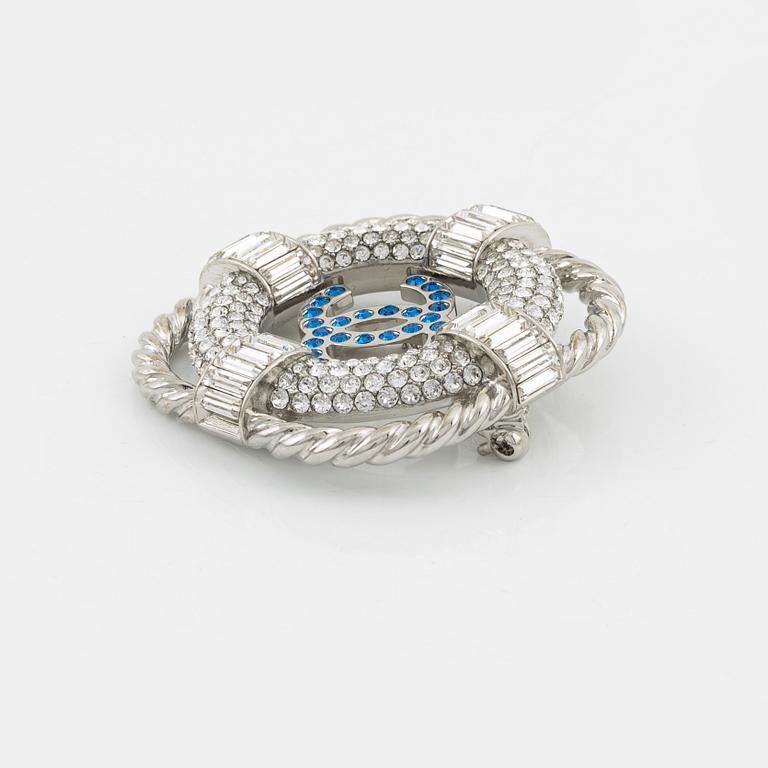 Chanel, a silvermetal, rhinestone and crystal brooch, 2019.