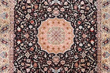 An old Tabriz carpet, c. 390 x 296 cm.