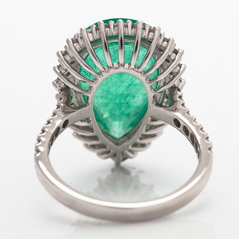 A 14K white gold ring, with a pear-cut  emerald ca. 7.72 ct and diamonds.