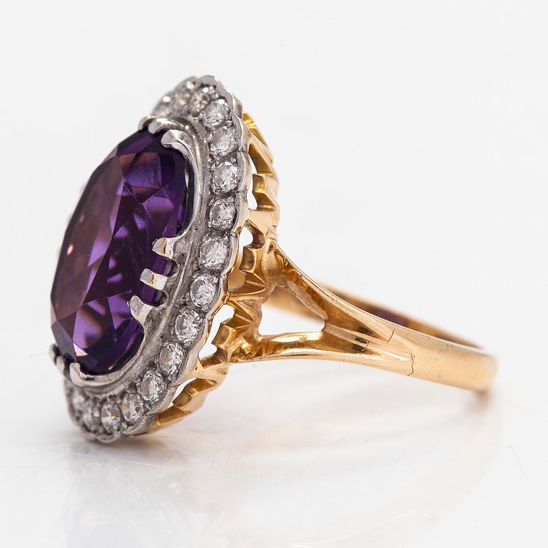 An 18K gold ring, with an oval faceted amethyst and diamonds totaling approximately 0.60 ct. Finnish marks.