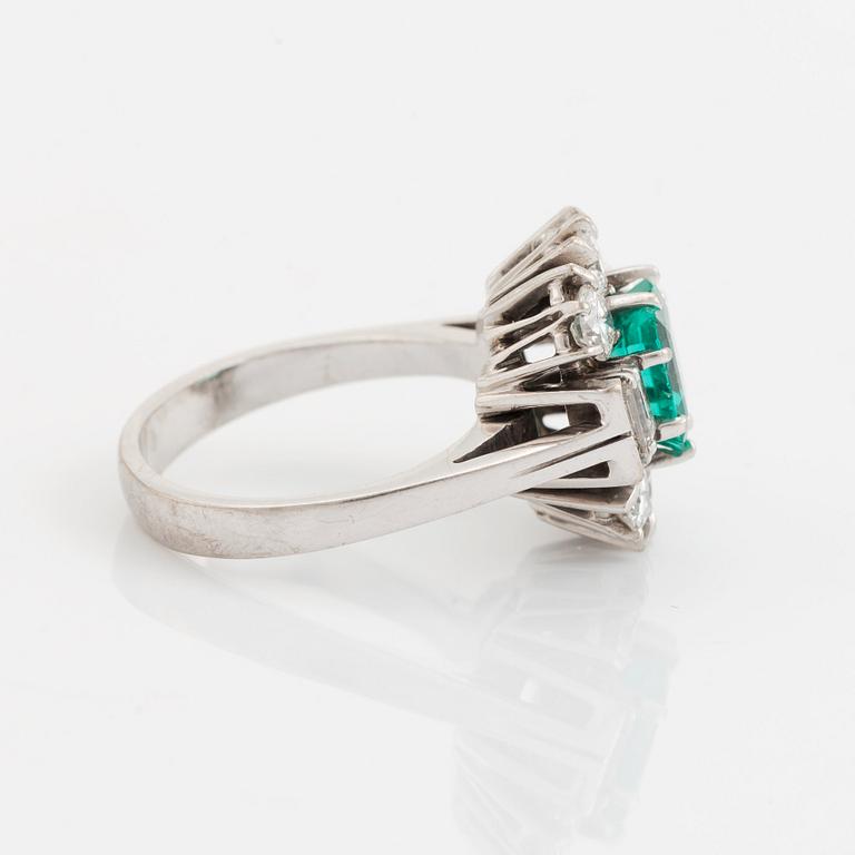 An 18K white gold ring set with a step-cut emerald.
