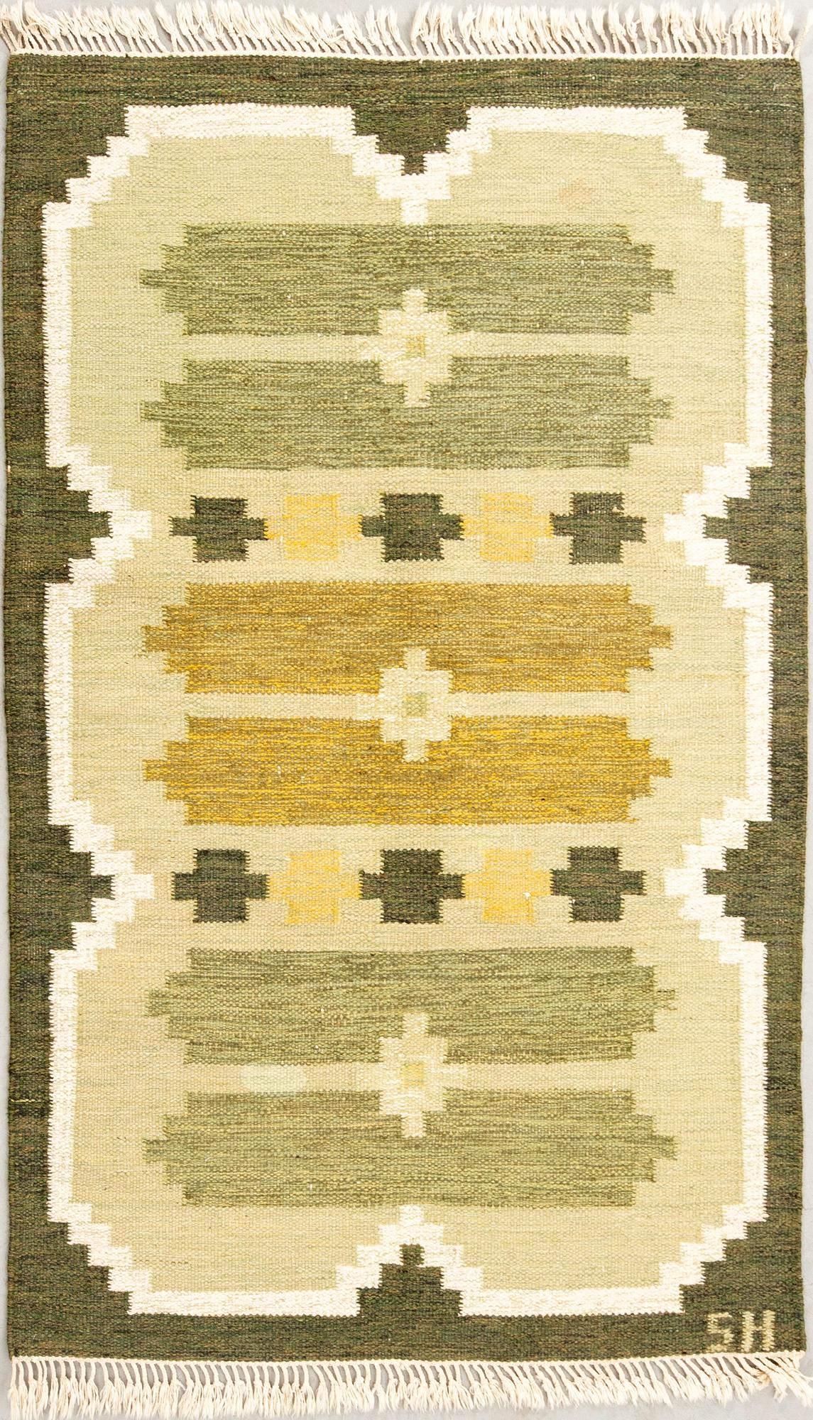 Flat-weave rug signed SH, approximately 194x133 cm.