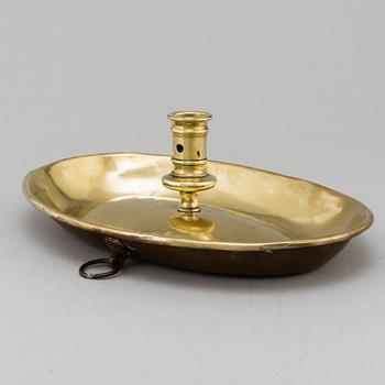 An 18th century brass candlestick.