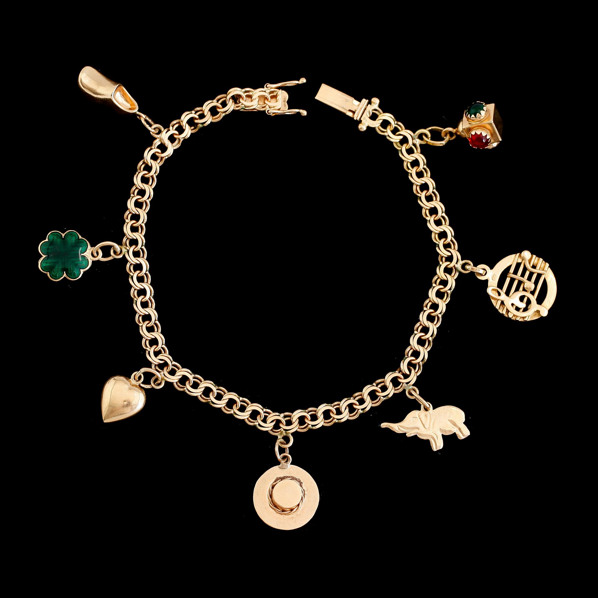 ARMBAND, 18K guld, Bismarcklänk, med 7 st berlocker. Vikt ca 13 g.