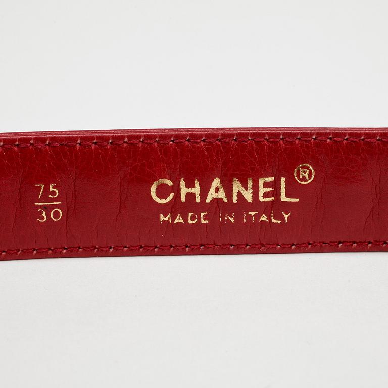 CHANEL, a red leather and gold chain belt.