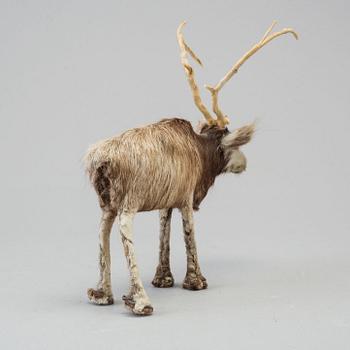 A Sami reindeer fur figure of a reindeer.