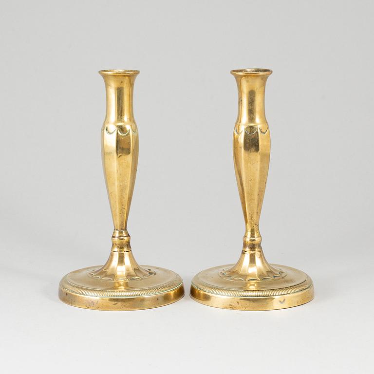 A pair of brass candlesticks, first half of the 19th century.