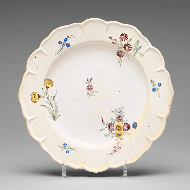 A set of six odd Swedish faience plates, Marieberg and Rörstrand, 18th Century.