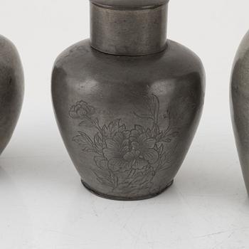 Two Japanese pewter vases and two tea caddies with covers, 20th Century.