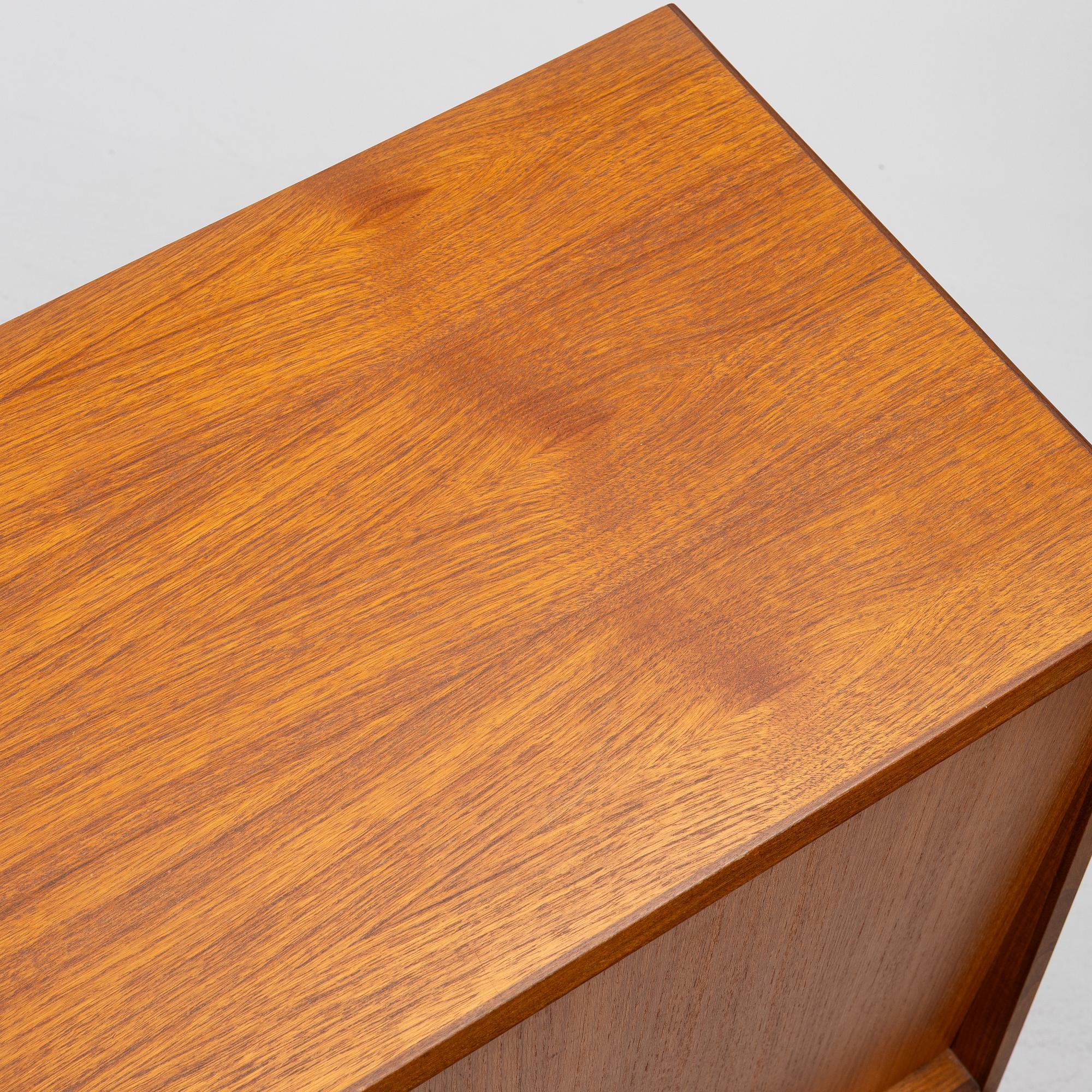 A mid20th century teak-veneered sideboard.