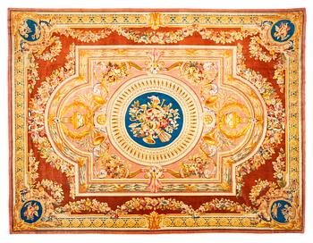 235. A carpet in savonnerie technique, ca 560 x 429 cm, Louis XVI style.