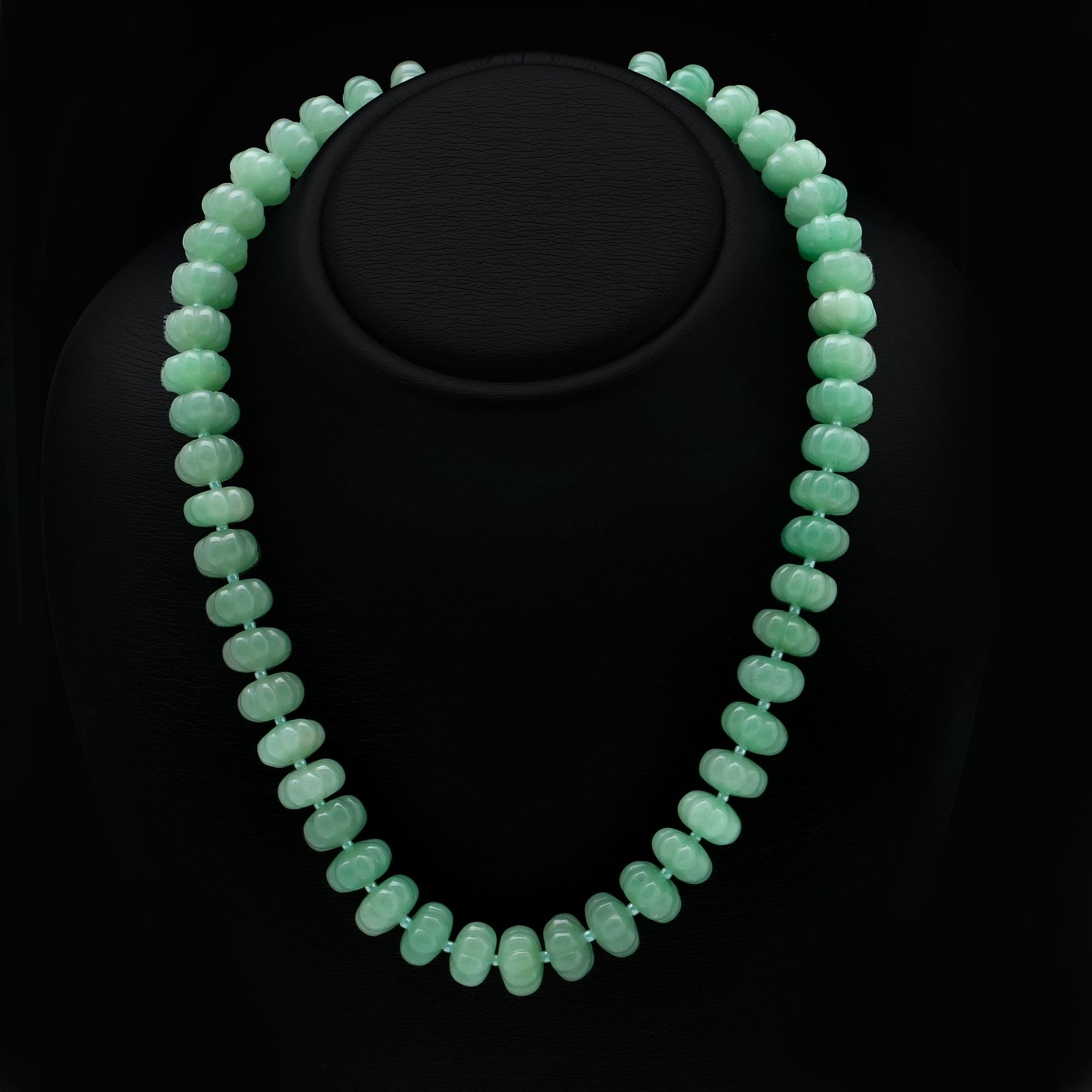 Necklace carved jade beads approx 15 mm and smaller glass beads , clasp metal, approx 50 cm.