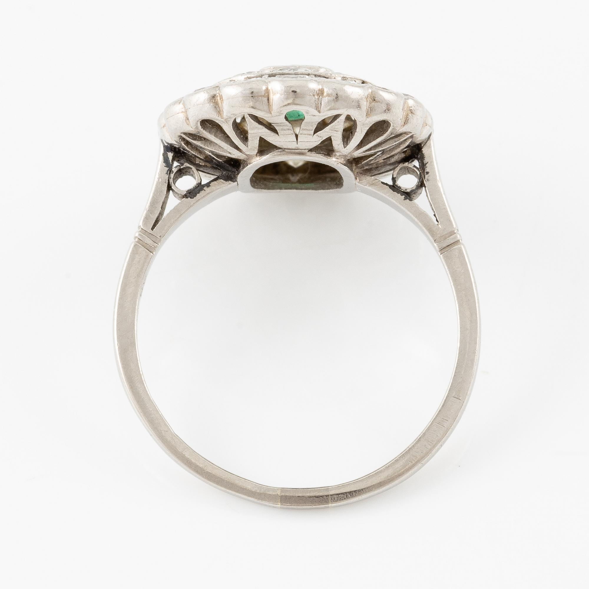 Platinum ring with an emerald and brilliant-cut diamonds.