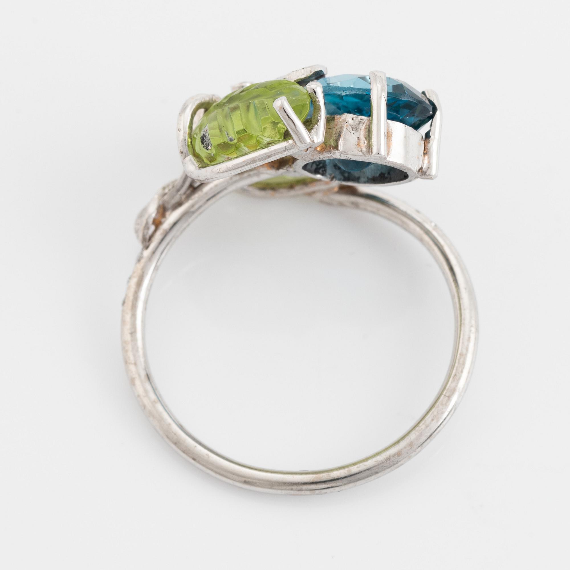 Blue topaz, carved peridot leaf, brilliant cut diamond ring.
