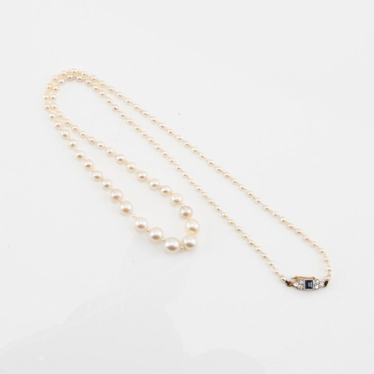 Necklace possibly cultured pearls with a clasp of 18K gold set with diamonds and a blue stone.