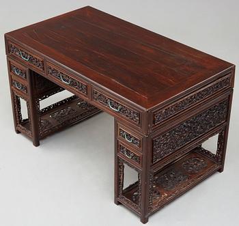 A carved hardwood desk, late Qing dynasty, circa 1900.