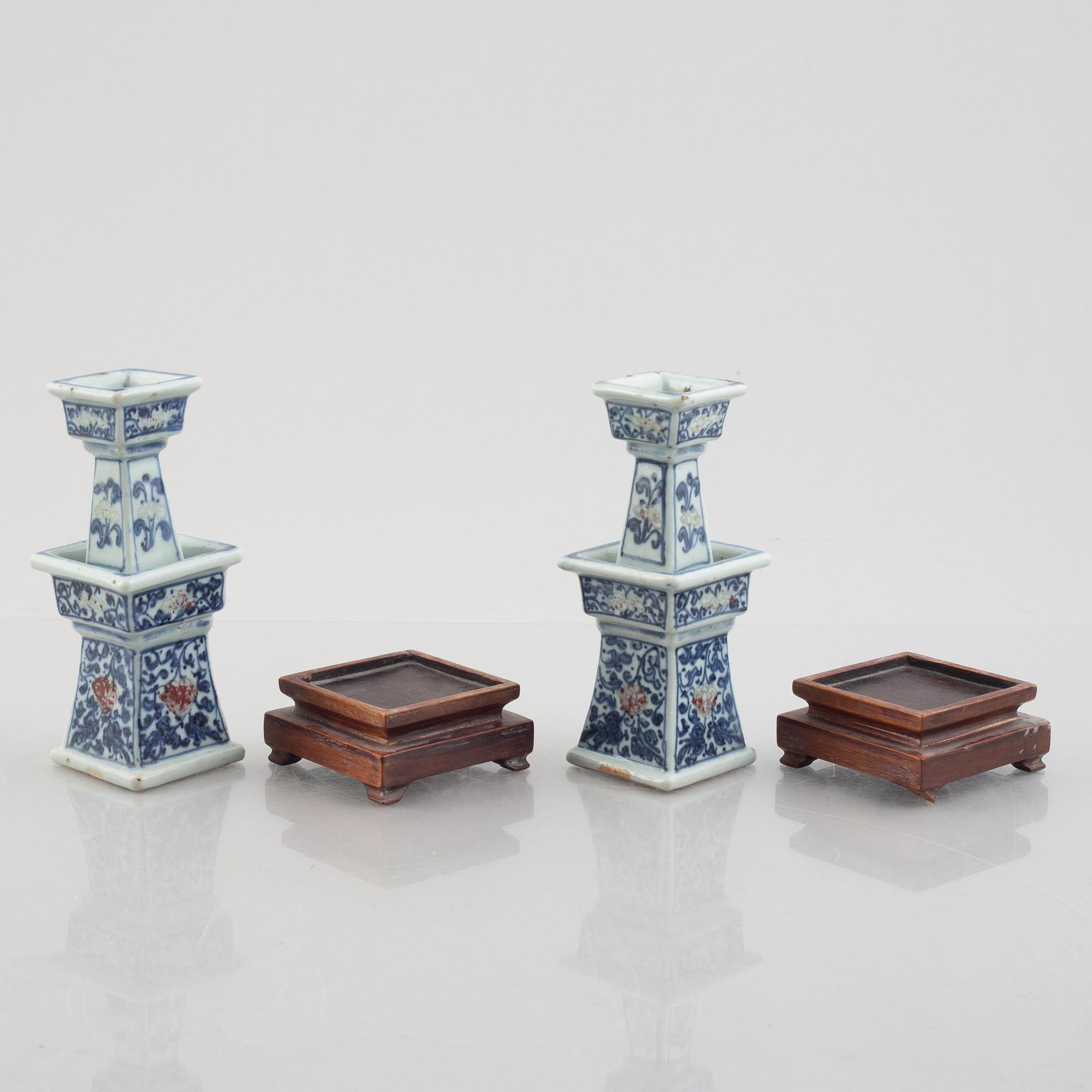 A pair of Chinese porcelain altar sticks, late Qing dynasty.
