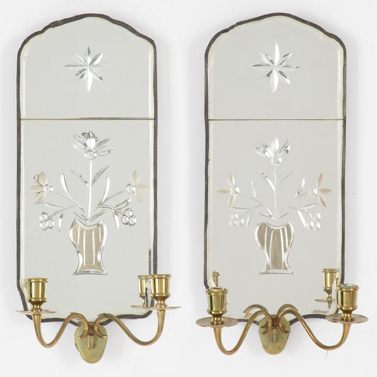 A pair of Swedish rococo engraved glass two-branch girandole mirrors, later part 18th century and later.
