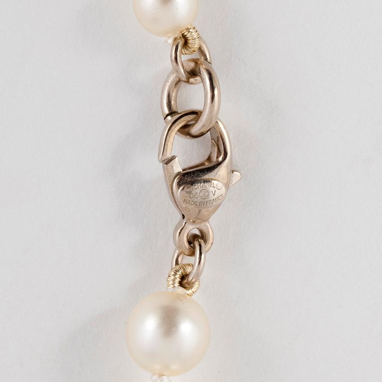 CHANEL, a decorative pearl necklace.