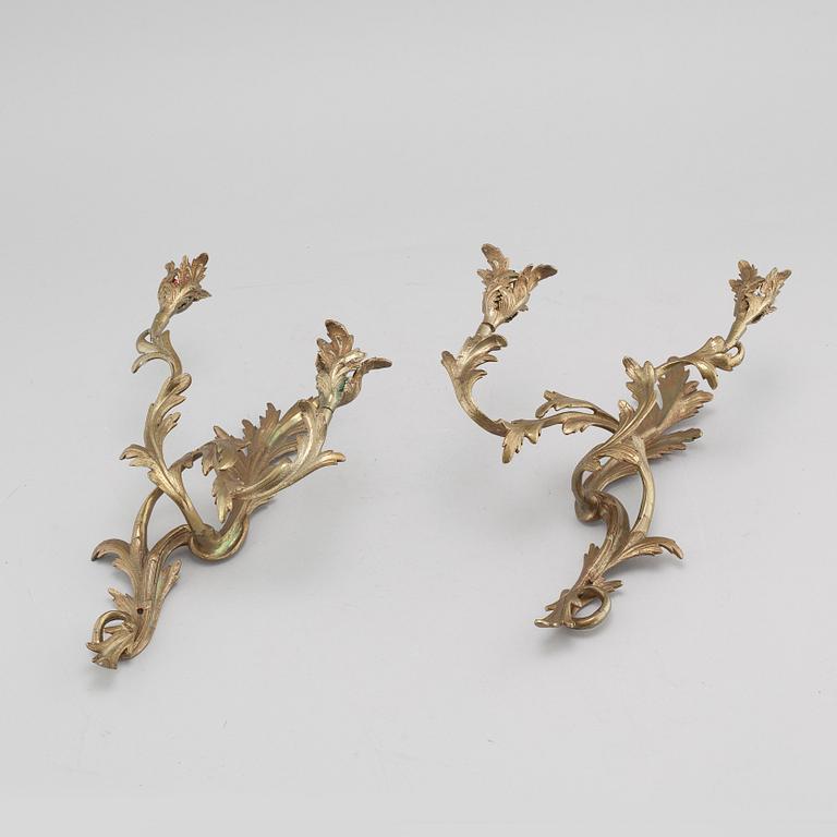 A pair of Louis XV-style brass wall sconces first half of the 20th century.
