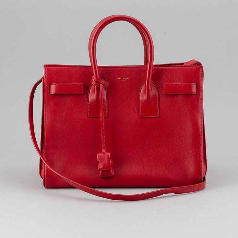Saint Laurent, a red leather 'Sac du Jour Small' bag.