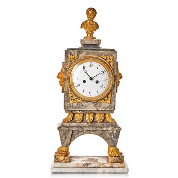 A marble and bronze Empire mantel clock.