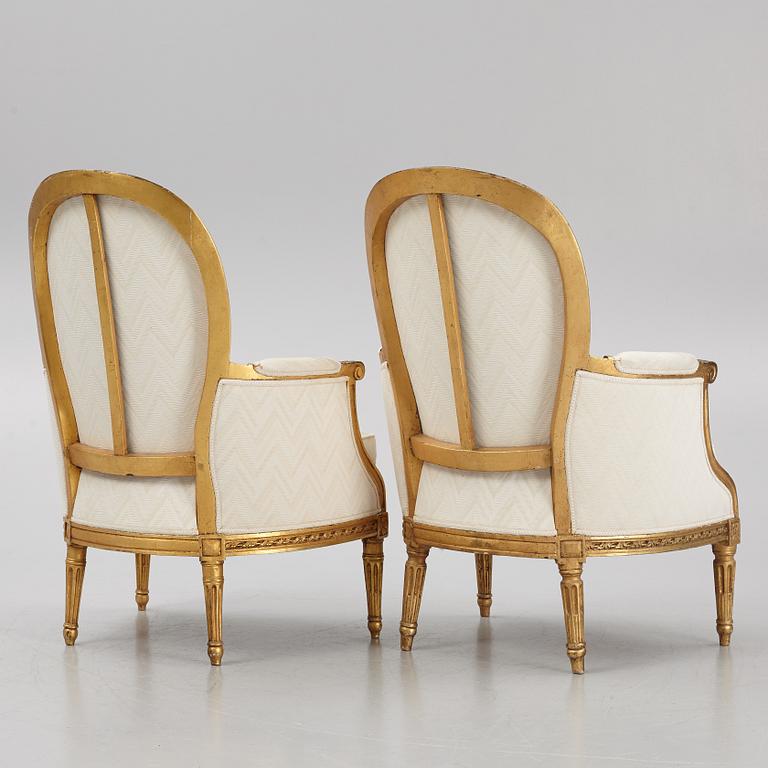 A near pair of French Louis XVI giltwood bergères, Paris, late 18th century.