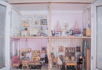 A doll house with interior and dolls ca 1910.